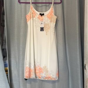Short white dress with sequins and bead detailing